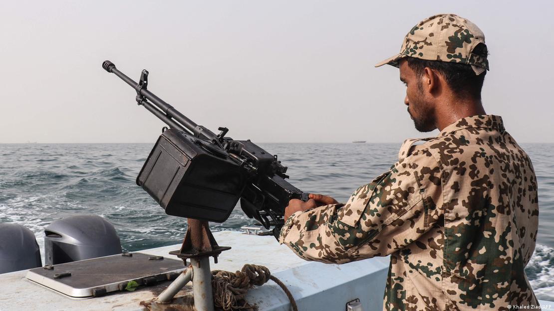 A sailor stands behinf a machine-gun aboard a vessel patrolling a shipping lane off Hanish Island in the Red Sea A sailor stands behinf a machine-gun aboard a vessel patrolling a shipping lane off Hanish Island in the Red Sea