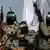 Palestinian fighters from the military wing of the Hamas movement seen on the back of a truck during a military parade