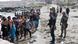 Spanish soldiers hold back a group of migrants who crossed the border from Morocco into the exclave of Ceuta, Spain, on July 31, 2026 Spanish soldiers hold back a group of migrants who crossed the border from Morocco into the exclave of Ceuta, Spain, on July 31, 2026