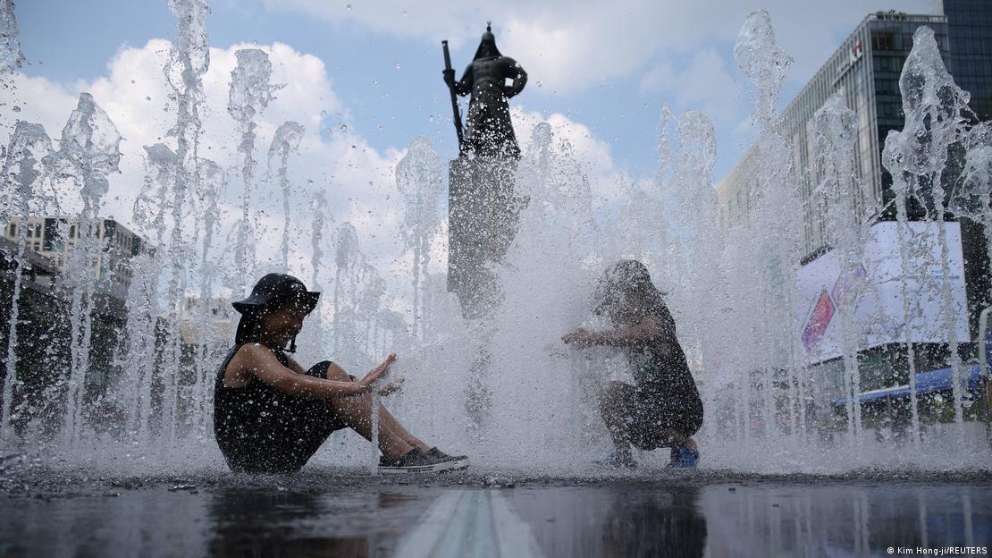 Children play at water fountain