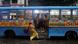 India Kolkata 2026 | A woman boards a bus along a water-logged road after heavy rains in Kolkata India Kolkata 2026 | A woman boards a bus along a water-logged road after heavy rains in Kolkata