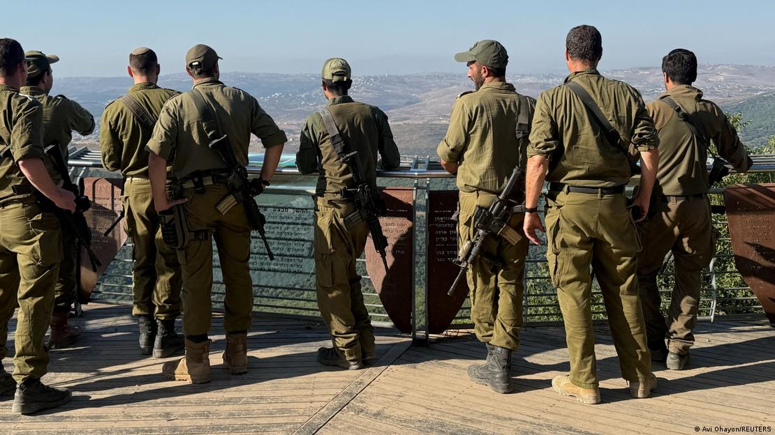 Image 1: Israeli soldiers look towards Lebanon from the Israeli side of the Israel-Lebanon border