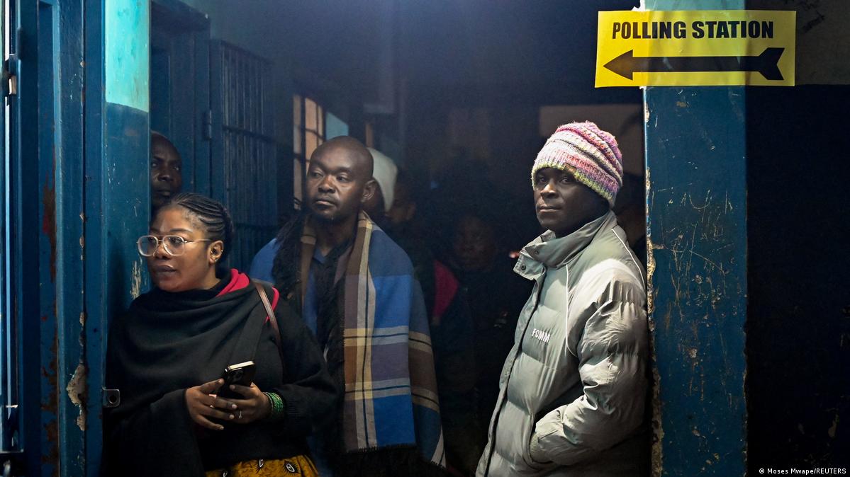 Voters waiting outside a polling station in Lusaka