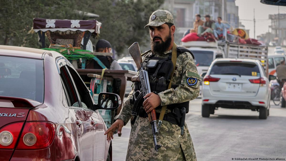 A Taliban policeman, armed with an assault rifle, directs traffic in Kabul (August 2025)