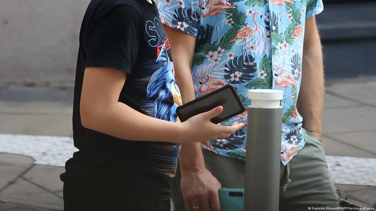 Teenager playing with his mobile phone