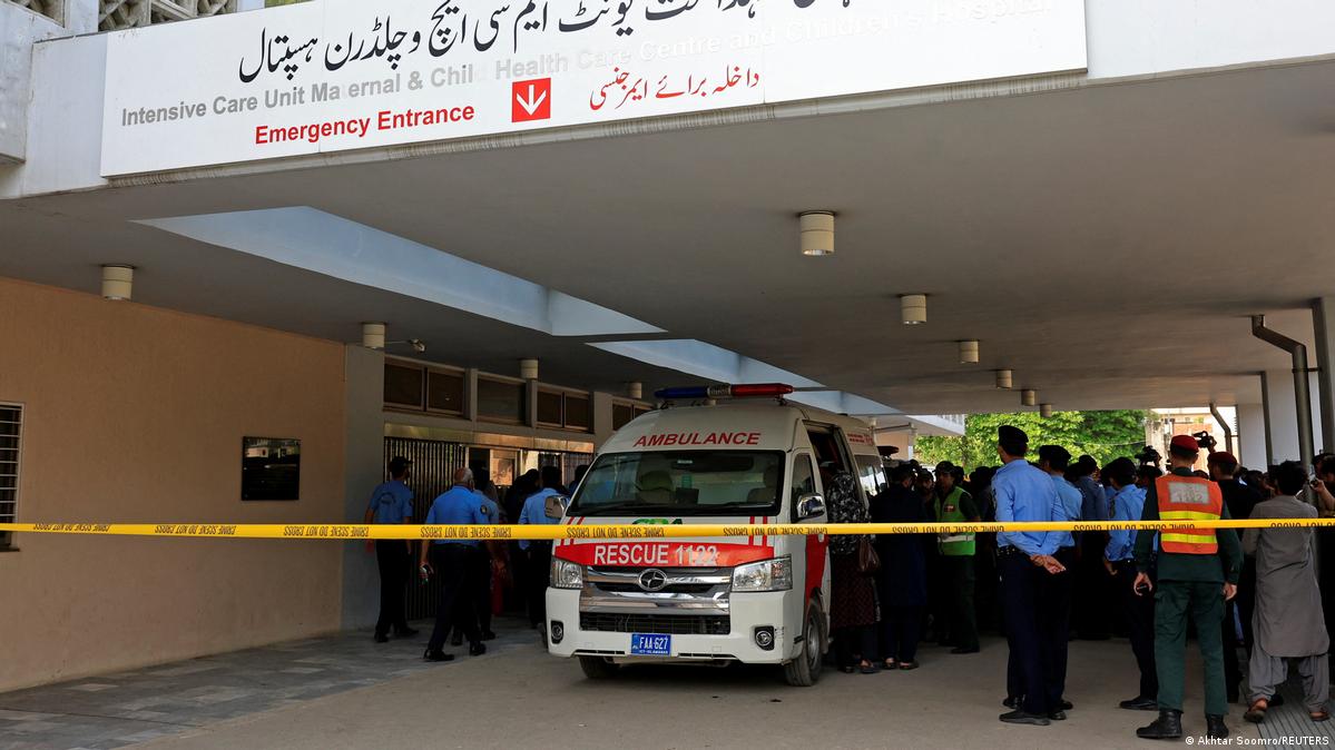 Police officers move past an ambulance outside an intensive care unit after a fire broke out at the Pakistan Institute of Medical Sciences (PIMS) hospital in Islamabad, Pakistan