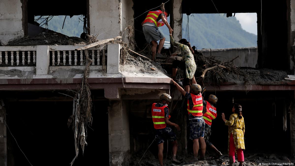 Nepal Trishuli 2026 | Rescuers helps a woman to get into her damaged house to salvage her belongings
