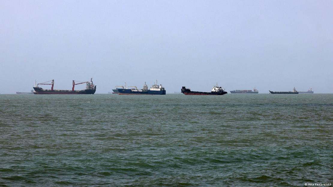 Six or seven ships lined up on the sea. Six or seven ships lined up on the sea.