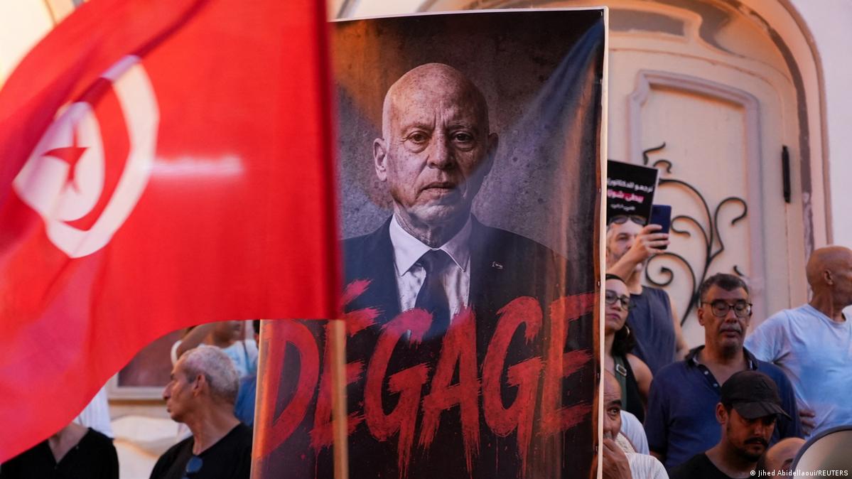 Demonstrators in Tunis hold a photo of Tunisian President Kais Saied that calls on him to step down
