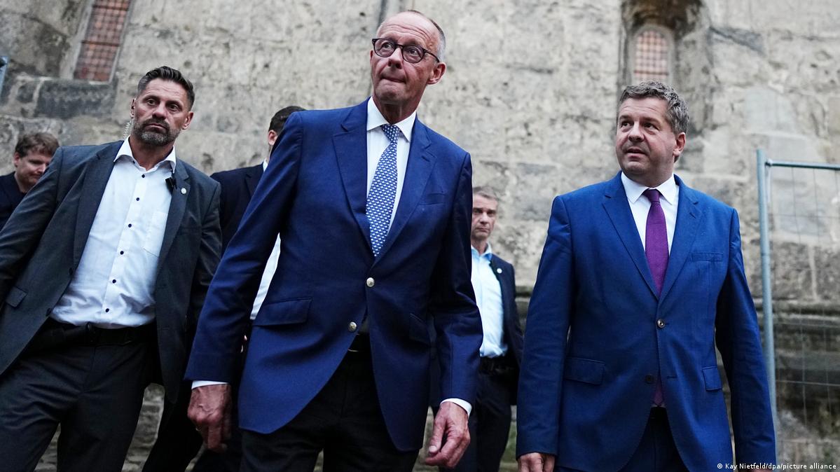 Chancellor Friedrich Merz and Sven Schulze walking past the Stiftskirche in Quedlinburg on their way to a campaign event on August 31, 2026