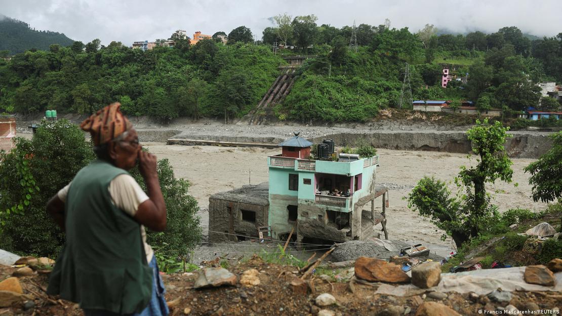 Un hombre observa la "casa verde milagrosa" en medio de los escombros tras haber sobrevivido a inundaciones repentinas en Trishuli, Nepal. Un hombre observa la "casa verde milagrosa" en medio de los escombros tras haber sobrevivido a inundaciones repentinas en Trishuli, Nepal.