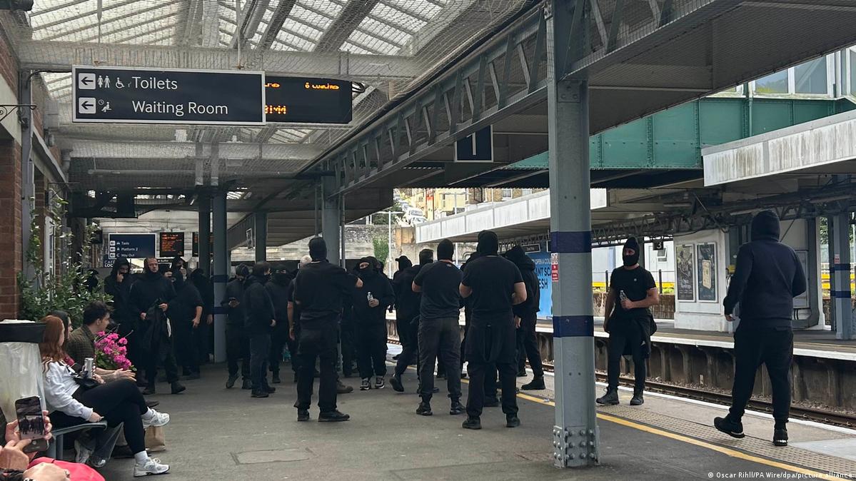 Masked men on a UK train platform