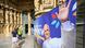 People enter the Saint-Etienne Cathedral where a banner displays a picture of Pope Leo XIV waving