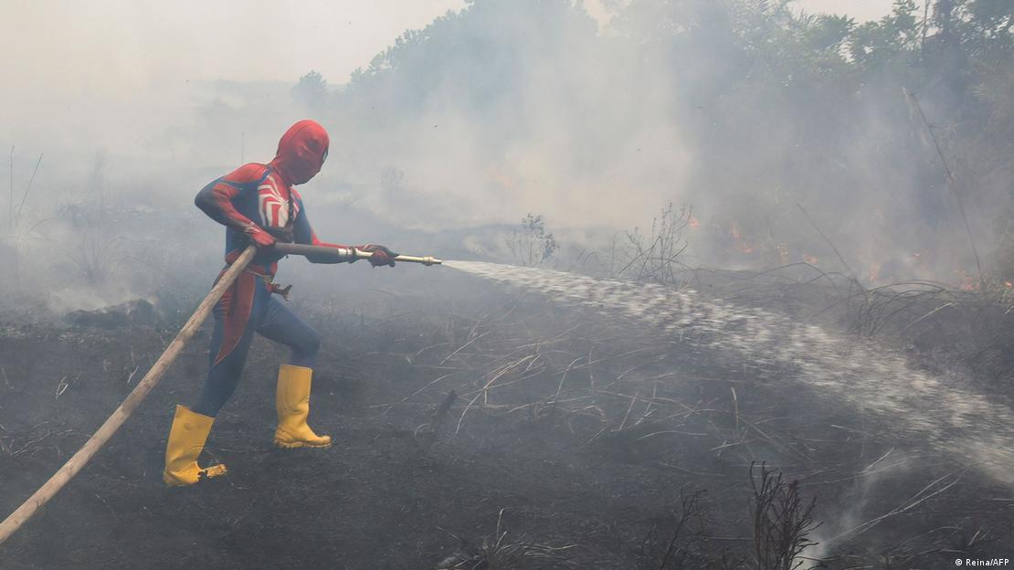 A resident wearing a Spider-Man costume extinguishes a land fire at Kereng Bangkirai in Palangkaraya, Central Kalimantan, on September 9, 2026