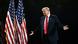 Donald Trump in a suit and red tie smirks as he raises his arms in a shrug Donald Trump in a suit and red tie smirks as he raises his arms in a shrug