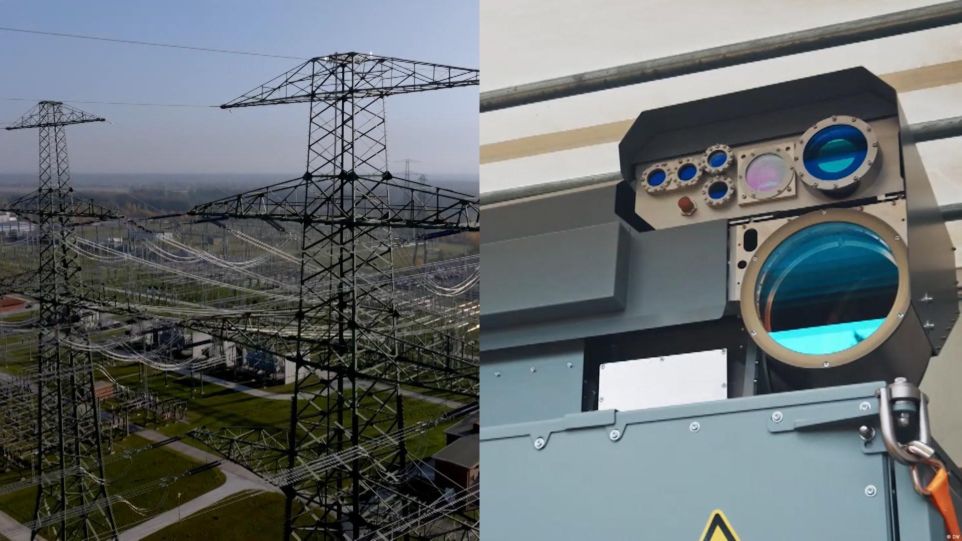 Hannover'de kritik altyapının korunmasını simgeleyen bir görüntüde elektrik iletim hatları ile bir güvenlik kamerası yan yana yer alıyor.