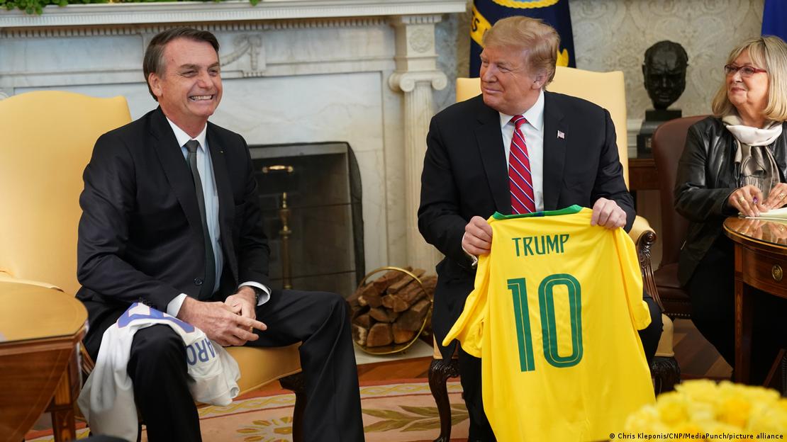 Donald Trump holds up a Brazil jersey next to Jair Bolsonaro at the White House in 2019