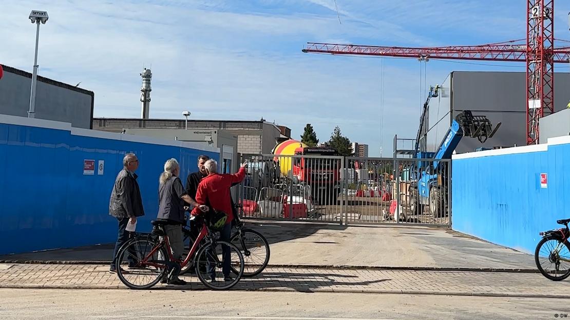 Image 1: A group of people outside the gates to the data center site