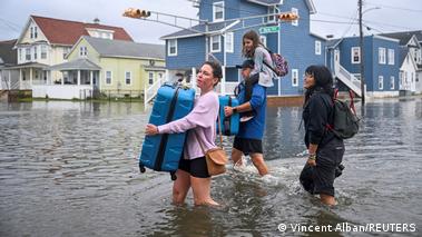 Image 9: Wildwood, USA, 2026 | Family with their belongings on a flooded street after a Nor'easter storm