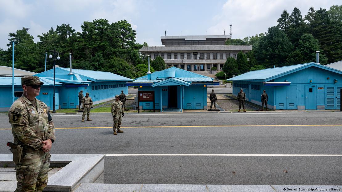 Image 1: Soldiers stand by the blue barracks at the Demilitarized Zone (DMZ) between South and North Korea