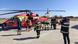 Image 9: Rescue crews stand by a helicopter in Romania