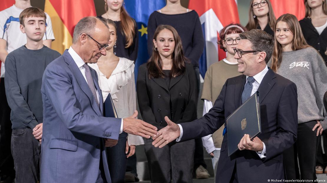German Chancellor Friedrich Merz shakes UK Prime Minister Andy Burnham's hand during talks in Berlin, Germany, on October 8, 2026