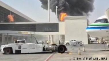 Image 6: Smoke and flames rise from the main international airport in Riyadh on October 8, in this screengrab obtained from a social media video.