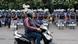 A man on a scooter passes members of the Rapid Action Force (RAF) standing guard A man on a scooter passes members of the Rapid Action Force (RAF) standing guard
