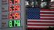 Gas prices at a Shell gas station and a US flag Gas prices at a Shell gas station and a US flag
