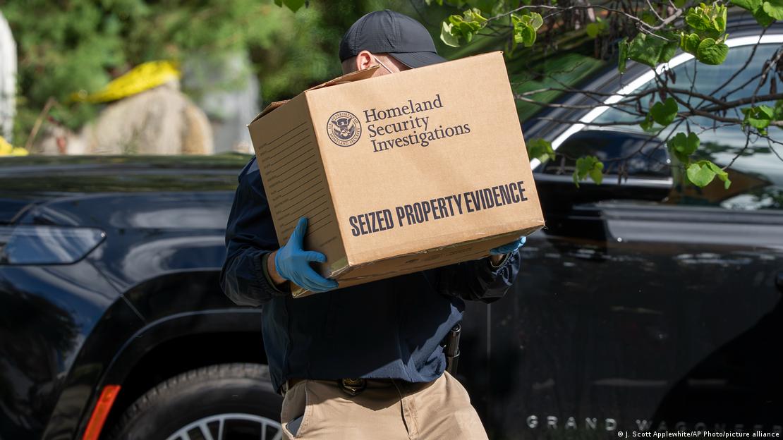 A US Federal Agent carries a box