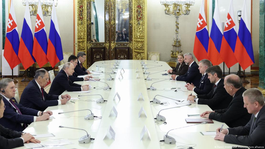 Russian and Slovak delegations sit facing each other on either side of a long conference table in an ornately decorated room. Two rows of Russian and Slovak flags can be seen in the background, Moscow, Russia, May 9, 2026