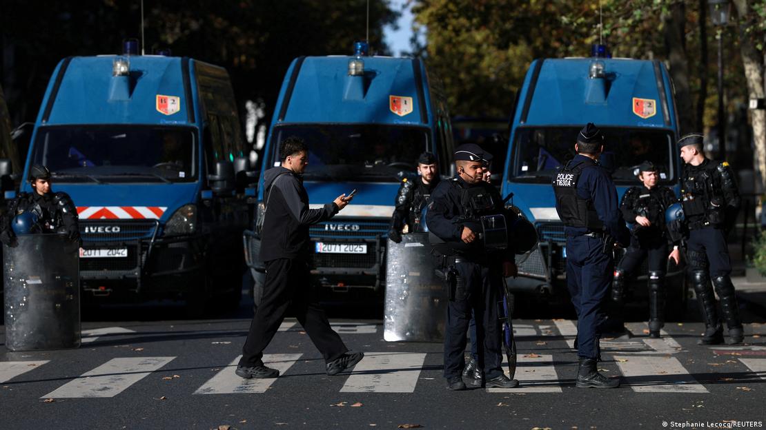 French gendarmes and police stand in position at the Place de la Republique during a demonstration against the cost of living and rising fuel prices
