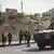 Israeli soldiers gather at the scene of a shooting attack carried out by Palestinian gunmen at a junction near Hebron in the occupied West Bank on Friday, Oct. 23, 2026