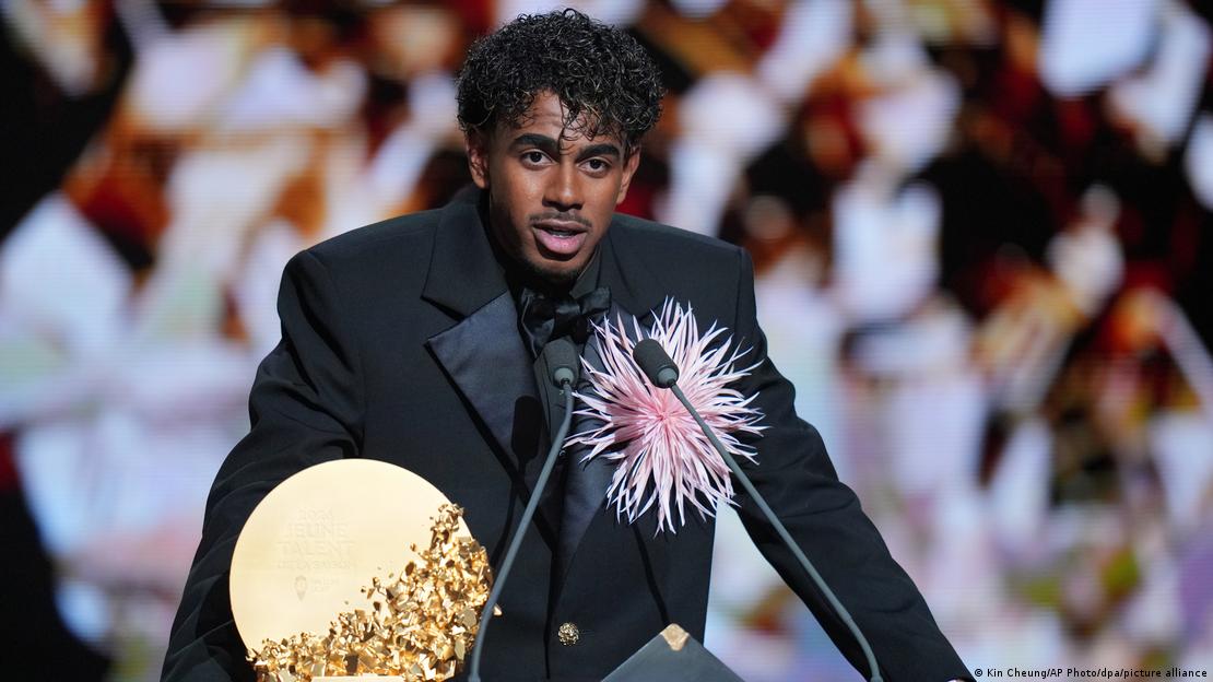 Lamine Yamal speaking into a microphone at the Ballon d'Or award event