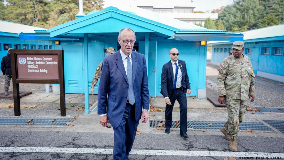 Germany's Friedrich Merz, followed by security, leaves a barrack at the demilitarized zone between the two Koreas (October 30, 2026)