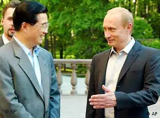 Russian President Vladimir Putin, right, and his Chinese counterpart Hu Jintao speak prior to an informal dinner at Putin's residence in Novo-Ogaryovo outside Moscow, Monday, May 26, 2003. Chinese President Hu Jintao arrived in Russia on Monday on his first trip abroad since his ascension to power - a visit intended to underline the importance of the two nations' so-called strategic partnership and help forge closer economic ties. (AP Photo/ Ivan Sekretarev, Pool)