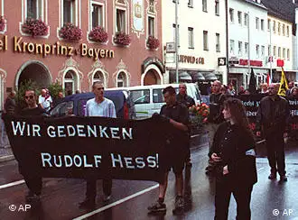 Neo-Nazis take to the street during a rally in memory of Adolf Hitler's deputy Rudolf Hess in Hess' Bavarian hometown of Wunsiedel, southern Germany, on Saturday, Aug. 17, 2002. Hess, who committed suicide in Berlin's Spandau prison 15 years ago, is a martyr to the extreme-right. Banner reads: We commemorate Rudolf Hess. (AP Photo/Udo Bartsch)